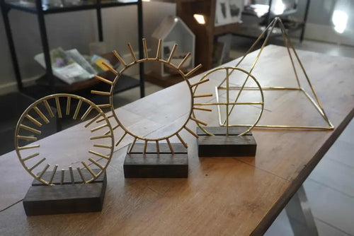 Gold geometric sculpture on black base in Krystaline High Frequency Bundle 4-inch tools