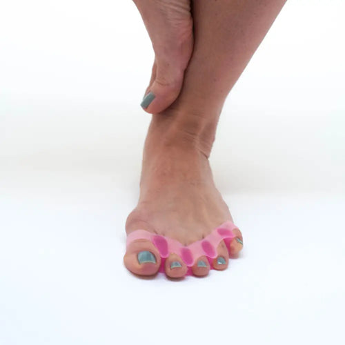 Pink silicone Toe Trainers toe separator on foot