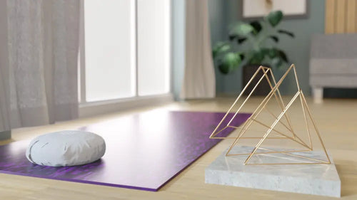 Triple pyramid gold geometric wire sculpture on white marble base